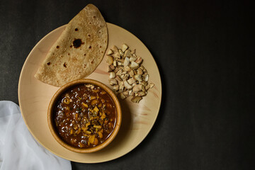 seasonal mushroom vegetable with bread/chapati on a black background