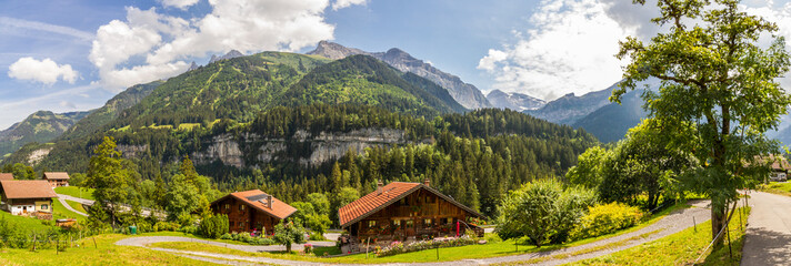 Panorama of Champéry, Switzerland, Canton Valais, with typical houses and mountain range Dents du...