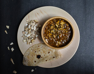 seasonal mushroom vegetable with bread/chapati on a black background