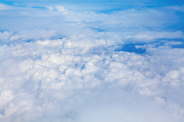 Cumulus fluffy clouds . Flying over the clouds
