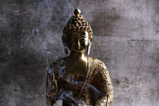 Brass sculpture of Gautam Buddha. Over grey background