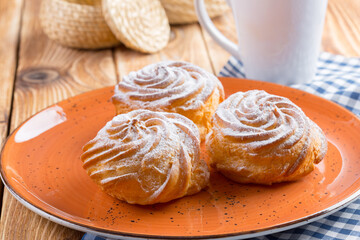 Small french cookies profitroles with sugar powder