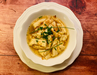 Pancake soup. Clear soup with strips of pancake, served with chive.