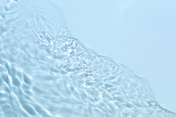 Blurred transparent blue colored clear calm water surface texture with splashes and bubbles. Trendy...