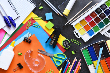 School supplies on a black background. Back to school concept.Flat lay composition with school stationery.