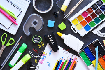 School supplies on a black background. Back to school concept.Flat lay composition with school stationery.