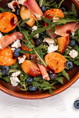 Grilled peach salad with lettuce, blue cheese, prosciutto, dor blue cheese, Delicious breakfast or snack, top view