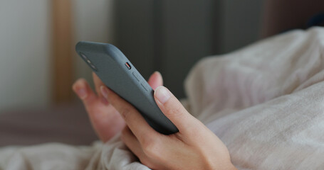 Woman use cellphone on bed