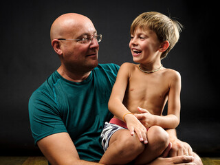 Pope and son exchange affectionate gestures.