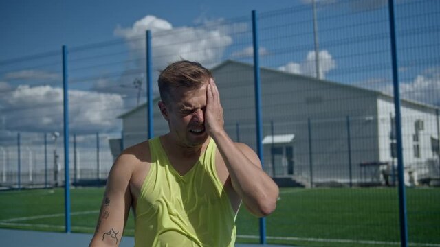 Stressed tennis player throwing and breaking a racket in anger and rage at court to net. Human emotions, defeat, crash, failure, loss concept. Professional Athlete Training, motivational video.