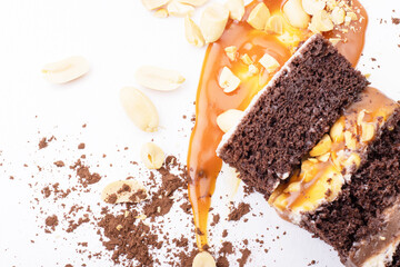 Delicious cream-caramel dessert with peanuts on a white background