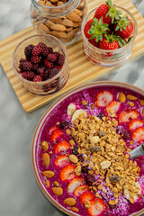Tasty dragon fruit smoothie bowl with berries and toppings