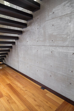bottom of bleachers, wooden floor and gray wall