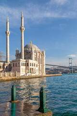 Fototapeta na wymiar Ortakoy Mosque known also as Mecidiye Mosque, with Bosphorus Bridge connecting Europe to Asia, in the background, in Istanbul, Turkey