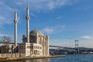 Fototapeta na wymiar Ortakoy Mosque known also as Mecidiye Mosque, with Bosphorus Bridge connecting Europe to Asia, in the background, in Istanbul, Turkey