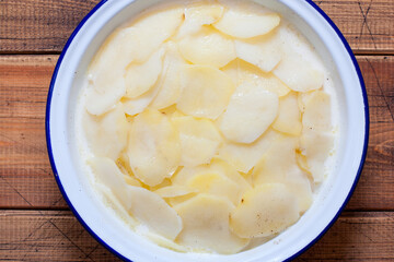 Step by step cooking boulanger potato casserole, step 8 - bake without foil, top view, selective focus
