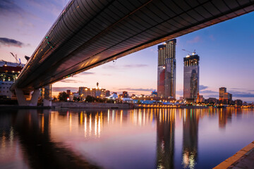 Fototapeta premium Panorama glass skyscrapers with night illumination in Moscow