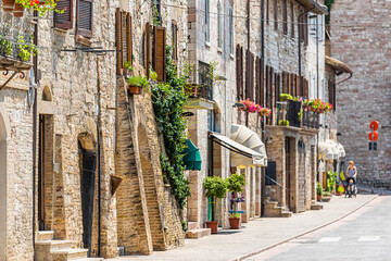 Fototapeta na wymiar Assisi, Italy city in Umbria sunny summer day with stone architecture and road street in historic St Francis town village