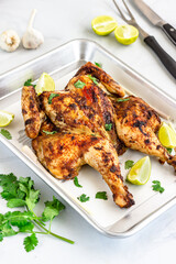 Thai Barbecued Whole Chickenon a Baking Tray with Cilantro, Lemon and Lemongrass Vertical Photo