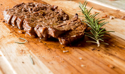 family barbecue beautiful beef cuts on a wooden board with a touch of excellent rosemary combination