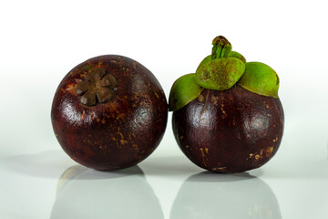 mangosteen showing sides and bottom of the fruit. Mangosteen is nicknamed the Queen of Fruits. A tropical fruit