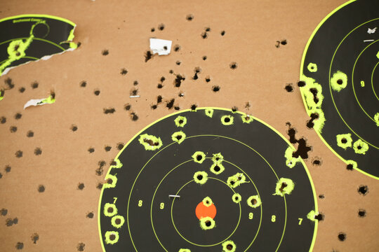 Shot up target full of holes at the gun range