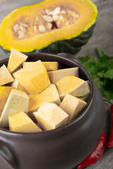 Kabocha pieces on a bowl with half fruit