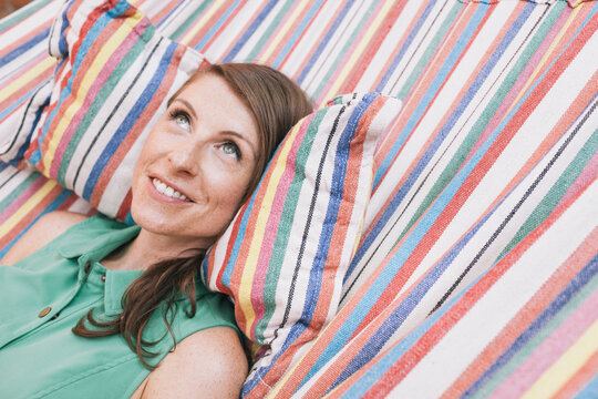 Young woman daydreaming in a hammock