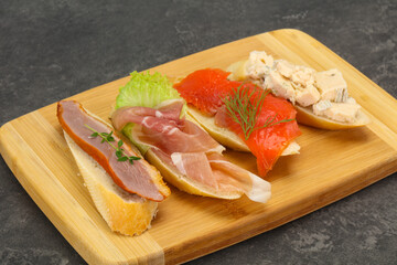 Tapas - bruschetta with prosciutto, salmon, duck and gorgonzola