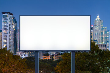 Blank white road billboard with Bangkok cityscape background at night time. Street advertising poster, mock up, 3D rendering. Front view. The concept of marketing communication to promote idea.