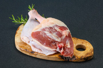Raw duck leg served rosemary