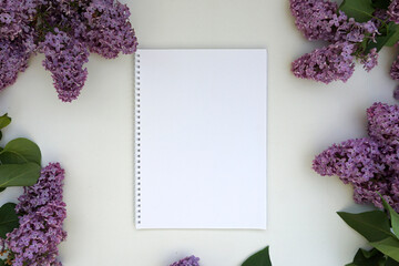  mock up of an empty notebook framed by lilac branches