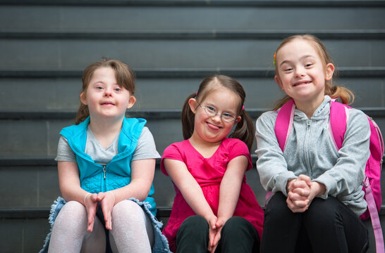 Adorable Elementary Aged Children with Down Syndrome on School Steps