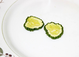 The remains of cut dried cucumbers lie on a plate.