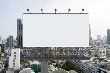 Obraz premium Blank white road billboard with Bangkok cityscape background at day time. Street advertising poster, mock up, 3D rendering. Front view. The concept of marketing communication to promote or sell idea.