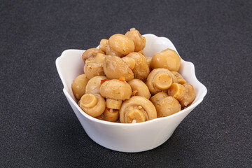 Pickled champignons in the bowl