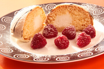 Delicious breakfast. Raspberry berries with sponge cake in powdered sugar on a bright background