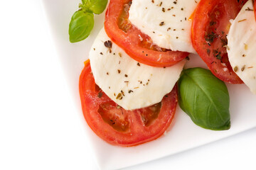 Traditional caprese salad with tomato and mozzarella cheese isolated on white background 