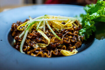 dry dark soy noodles (local name is Zajang noodle) with shredded egg crepes in restaurant in Vietnam.