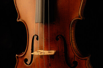 Antique Violin detail in moody lighting and black background