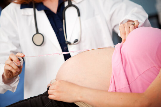 Exam Room: Doctor Measuring Size of Pregnant Tummy