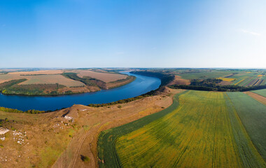 Fototapeta na wymiar Aerial view of the canyon with a large deep river. Sown fields along the banks. Reservoir concept, water resource, ecology. Landscape. Dniester, Nagoryany, nature of Ukraine