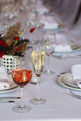 Wedding service. Festive table, wine glasses, white tablecloth. Plates and cutlery