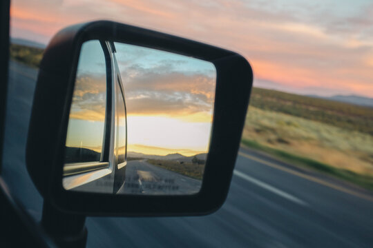Sunset in a moving car mirror