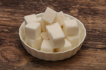 Refined white sugar cubs in the bowl