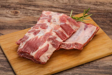Raw pork ribs served rosemary