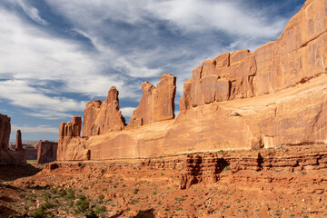 Beautiful red rock wall formation in a warm light at golden hour - Park Avenue Viewpoint and trailhead - Arches National Park, UT - USA