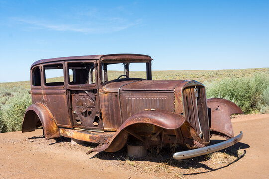 Aged abandoned rusty metal truck lies along historic Route 66 in Petrified Forest National Park - AZ, USA
