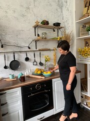 Beautiful girl in the kitchen is going to cook food