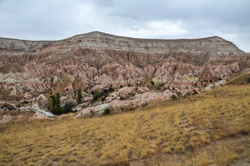 Natural valley with volcanic tuff stone rocks in Goreme in Cappadocia, Central Anatolia region of Turkey. Popular tourist destination in Turkey for trekking.